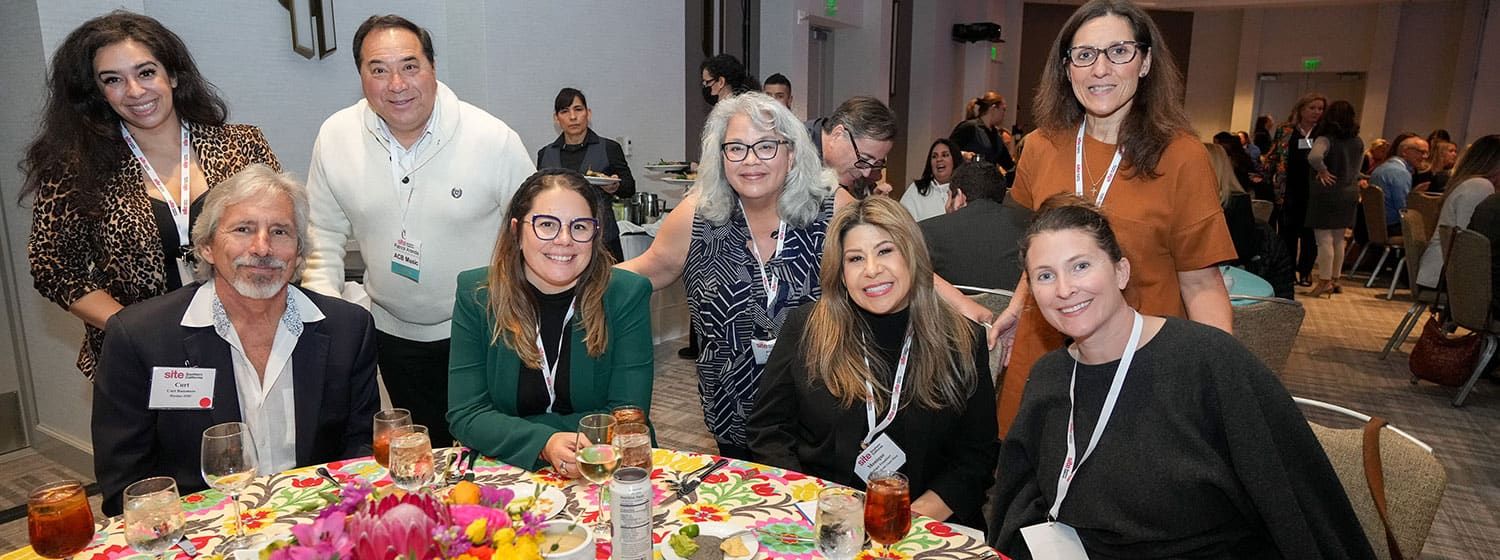 a group of happy SITE SoCal members posing at their lunch table